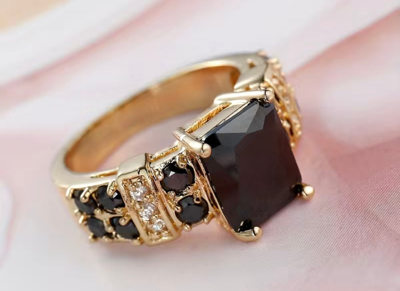Gold Color ring with a black jewel and black and clear crystals
